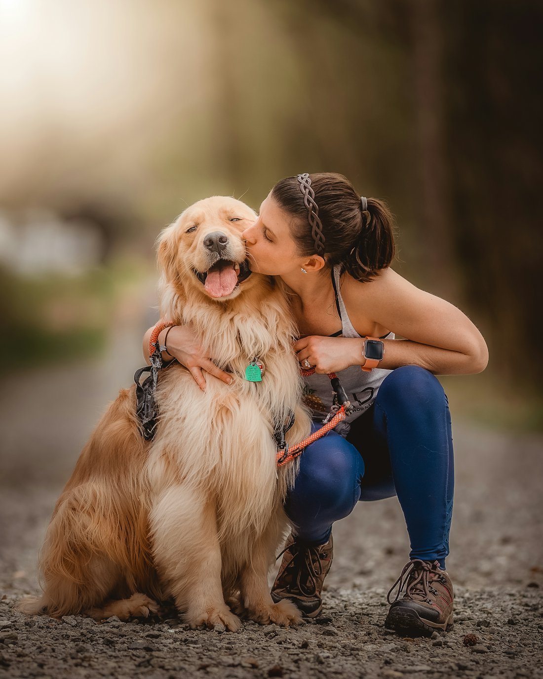 Une femme embrasse son golden retriever qui ferme les yeux de bonheur
